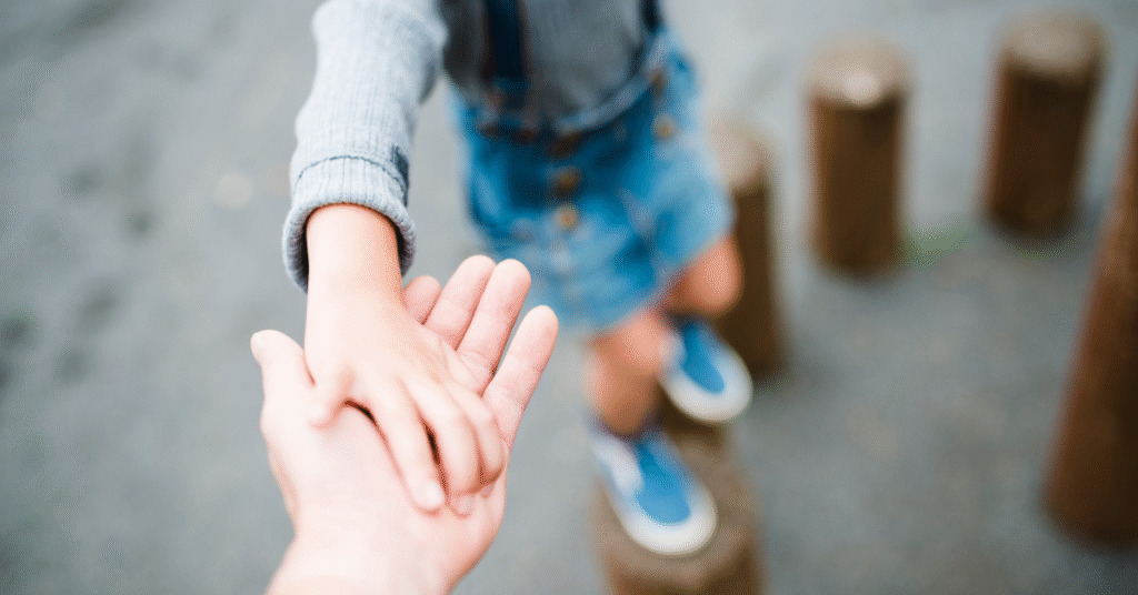 Hand reaching out with blurred background, symbolising fatherhood, connection, and support in family relationships