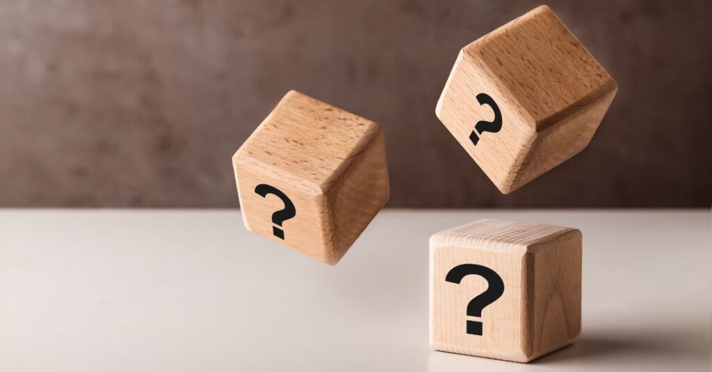 Three wooden blocks with question marks symbolising frequently asked questions about divorce and separation.