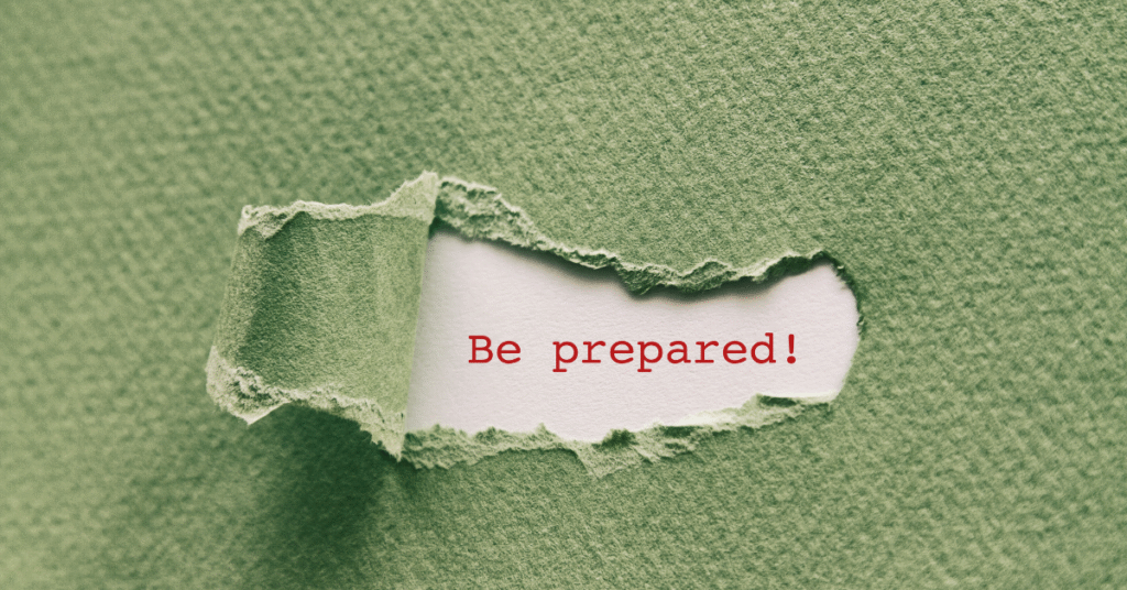A piece of paper with the words "Be prepared!" placed on a green fabric background, symbolising readiness for the divorce process.