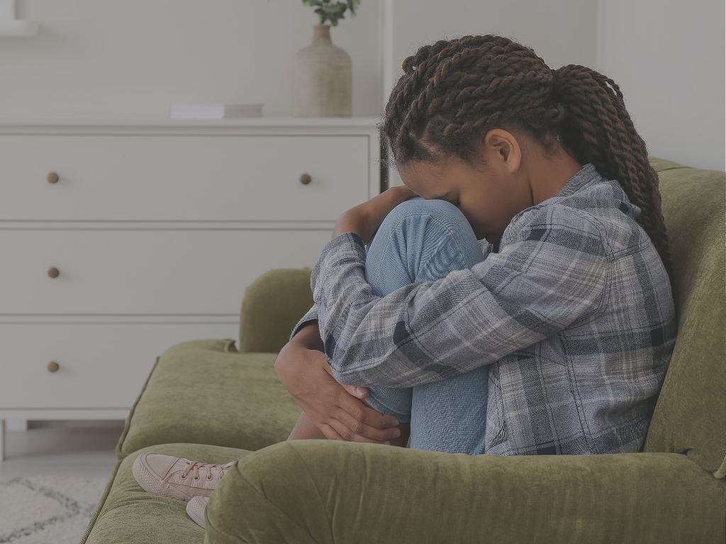 Child sitting on a couch, symbolising the emotional impact of family court delays on children and families.